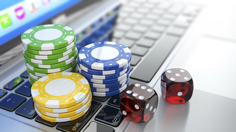 Online casino. Dices and chips on laptop.